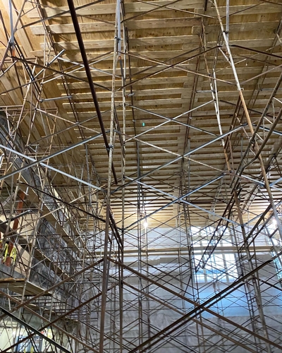 Traditional frame and brace scaffolding provided the strength to support the platform