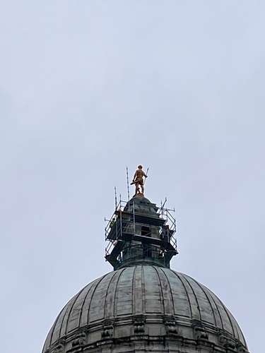 Building the scaffolding up to reach the Independent Man on top of the RI statehouse